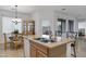 Kitchen featuring an island with barstool seating, a dining area, and access to the backyard at 42335 W Waterfall Way, Maricopa, AZ 85138
