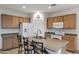 Kitchen showcasing a functional island with seating and modern appliances at 42335 W Waterfall Way, Maricopa, AZ 85138