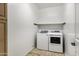 Practical laundry room with a modern washer and dryer, and a shelf at 42335 W Waterfall Way, Maricopa, AZ 85138