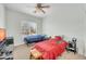 Comfortable bedroom with two beds, large window, and entertainment center at 44314 W Mescal St, Maricopa, AZ 85138