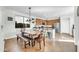 Eat-in kitchen features a wood dining table, breakfast bar and wood cabinetry at 44314 W Mescal St, Maricopa, AZ 85138