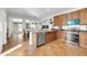 Kitchen boasts stainless steel appliances, wood cabinets, and a breakfast bar at 44314 W Mescal St, Maricopa, AZ 85138