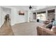 Inviting living room with carpet, large windows with blinds, and sliding doors to the backyard at 44314 W Mescal St, Maricopa, AZ 85138