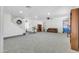 Bright and airy living room with a staircase, carpet, and ample space for furnishings at 44314 W Mescal St, Maricopa, AZ 85138