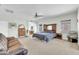 Expansive bedroom features a ceiling fan, and ensuite bathroom, and a leather sofa at 44314 W Mescal St, Maricopa, AZ 85138
