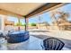 Covered patio area featuring a hot tub and view of the private backyard space at 44314 W Mescal St, Maricopa, AZ 85138