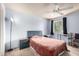 Comfortable bedroom with neutral carpet, ceiling fan, and a large window for natural light at 4554 E Paradise Village N Pkwy # 210, Phoenix, AZ 85032