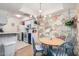 Open dining area and kitchen with chandelier and designer wallpaper at 4554 E Paradise Village N Pkwy # 210, Phoenix, AZ 85032