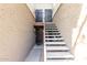 Exterior shot of a condo building with light colored stucco and front doors with wrought iron decoration at 4554 E Paradise Village N Pkwy # 210, Phoenix, AZ 85032