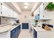 Traditional kitchen with white cabinets and appliances, ample counter space, and an adjacent eat-in bar at 4554 E Paradise Village N Pkwy # 210, Phoenix, AZ 85032