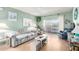 Cozy living room with a striped sofa, area rug, and sliding doors to a balcony with a hammock at 4554 E Paradise Village N Pkwy # 210, Phoenix, AZ 85032