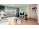 Comfortable living room with sliding glass doors to a balcony with a hammock and an entertainment center at 4554 E Paradise Village N Pkwy # 210, Phoenix, AZ 85032
