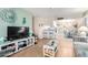 Bright open living room with hardwood floors, a TV, breakfast bar, and dining area with natural lighting at 4554 E Paradise Village N Pkwy # 210, Phoenix, AZ 85032