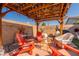 Cozy backyard patio area with corrugated roof, pavers, outdoor seating, and decorative lighting at 5012 S Girard St, Gilbert, AZ 85298