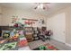 Themed bedroom featuring bed, shelves, ceiling fan, closet doors and playful decorations at 5012 S Girard St, Gilbert, AZ 85298