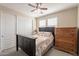 Cozy bedroom with a ceiling fan, closet, and bedside dresser at 5012 S Girard St, Gilbert, AZ 85298
