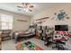 Themed bedroom with a ceiling fan, shelves and bright and playful decorations at 5012 S Girard St, Gilbert, AZ 85298