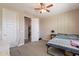 Bright bedroom with a ceiling fan, view to the closet, and natural light from the windows at 5012 S Girard St, Gilbert, AZ 85298