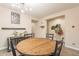Dining room with a round wooden table and adjacent hallway storage, offering a functional layout at 5012 S Girard St, Gilbert, AZ 85298