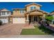 Charming two-story home featuring a covered porch, brick driveway, and two car garage at 5012 S Girard St, Gilbert, AZ 85298