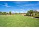 Large open green space with a pond, mature landscaping and walking trails in the community at 5012 S Girard St, Gilbert, AZ 85298