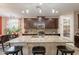 Kitchen area with dark cabinets, granite counters, stainless appliances, and an island with seating at 5012 S Girard St, Gilbert, AZ 85298