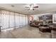 Living room flowing into the kitchen with wood-look tile flooring and an open layout at 5012 S Girard St, Gilbert, AZ 85298