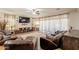 Well-lit living room features stylish decor, wood-look tile floors, and comfortable seating at 5012 S Girard St, Gilbert, AZ 85298