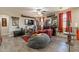 Cozy living room with tile flooring, a ceiling fan, and shelves displaying toys, creating a personalized space at 5012 S Girard St, Gilbert, AZ 85298