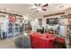 Well-organized living room area with a TV, memorabilia display, red armchair, and comfy beanbag chair at 5012 S Girard St, Gilbert, AZ 85298