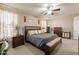 Spacious primary bedroom featuring hardwood furniture set and neutral color scheme at 5012 S Girard St, Gilbert, AZ 85298