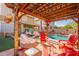 Charming backyard patio with pergola, string lights, and poolside views, creating a relaxing outdoor space at 5012 S Girard St, Gilbert, AZ 85298