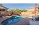 Backyard pool and hardscape enclosed with brick wall at 5012 S Girard St, Gilbert, AZ 85298
