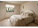 Cozy bedroom featuring neutral tones, a plush bed, and natural light from the window at 5101 N Casa Blanca Dr # 223, Paradise Valley, AZ 85253