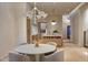 Dining area with seating for four, modern chandelier, and a view into the open kitchen at 5101 N Casa Blanca Dr # 223, Paradise Valley, AZ 85253