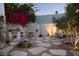 Charming outdoor kitchen and seating area with bougainvillea, perfect for entertaining guests in style and comfort at 5101 N Casa Blanca Dr # 223, Paradise Valley, AZ 85253