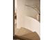 A sleek, minimalist staircase with light wood steps and curved white walls at 5101 N Casa Blanca Dr # 223, Paradise Valley, AZ 85253