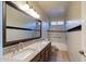 Bright bathroom featuring a double sink with granite countertops and updated fixtures at 5185 W Del Rio St, Chandler, AZ 85226