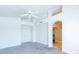 Bright bedroom with tall ceilings, fan, and an arched doorway leading to the bathroom at 5185 W Del Rio St, Chandler, AZ 85226