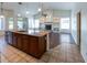 Modern kitchen island with granite countertop and view of fireplace and backyard at 5185 W Del Rio St, Chandler, AZ 85226