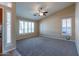 Bright living room featuring vaulted ceilings, large windows, and a ceiling fan at 5185 W Del Rio St, Chandler, AZ 85226