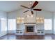 Bright living room with a fireplace, built-in shelving, and large windows at 5185 W Del Rio St, Chandler, AZ 85226