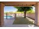 View of pool and grassy backyard from covered patio at 5185 W Del Rio St, Chandler, AZ 85226