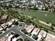 Aerial view of community featuring a scenic lake, lush green spaces, and well-maintained residential areas at 563 N Spanish Springs Dr, Chandler, AZ 85226