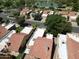 Aerial view of residential neighborhood with tree-lined streets near the lake, fountains, and surrounding community at 563 N Spanish Springs Dr, Chandler, AZ 85226