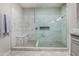 This modern bathroom features a spacious glass shower with bench seating and marbled tile at 563 N Spanish Springs Dr, Chandler, AZ 85226