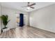 Bright bedroom features wood-look flooring, ceiling fan, and sliding glass doors to the backyard at 563 N Spanish Springs Dr, Chandler, AZ 85226