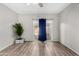 Bright bedroom features wood-look flooring, ceiling fan, and sliding glass doors to the backyard at 563 N Spanish Springs Dr, Chandler, AZ 85226