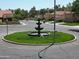 Picturesque neighborhood with a tiered fountain, mature trees, and well-manicured lawns at 563 N Spanish Springs Dr, Chandler, AZ 85226