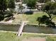 Scenic community featuring a bridge, mature trees, green spaces, and a walking path at 563 N Spanish Springs Dr, Chandler, AZ 85226
